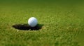 Successful putt as golf ball falls into hole Royalty Free Stock Photo