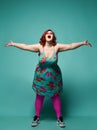 Successful redhead overweight fat woman happy loudly laughing, shouting, screaming, singing hit song with hands raised up spread