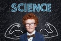 Successful school boy with ginger hair on science background. Learn science and science power concept Royalty Free Stock Photo