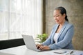 Successful senior businesswoman focuses on her business tasks on laptop Royalty Free Stock Photo