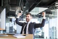 Successful seo man, boss business man, celebrates victory by working on computer in modern office Royalty Free Stock Photo