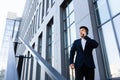 Successful serious asian businessman talking on the phone near the office center Royalty Free Stock Photo