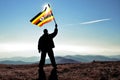 Successful silhouette man winner waving Uganda flag
