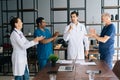 Successful skilled young doctor getting team applause in light office room at modern hospital. Royalty Free Stock Photo