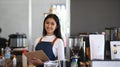 Successful small business owner smiling and standing behind the counter in the coffee shop. Royalty Free Stock Photo