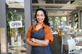 Successful small business owner standing at cafe entrance Royalty Free Stock Photo