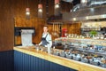 Successful small business owner woman standing behind counter of newly opened restaurant Royalty Free Stock Photo