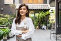 Successful small business young asian owner woman standing with looking at camera posing crossing arms, Portrait of waiter Royalty Free Stock Photo