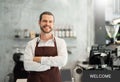 Bearded man wear brown apron looking at camera