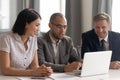 Successful smiling diverse colleagues listening to african american team leader. Royalty Free Stock Photo