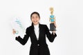 Successful smiling young Asian business woman celebrating with trophy award over white isolated background. Success achievement in Royalty Free Stock Photo