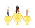 Successful, smiling, young businessman and businesswoman on podium. Little people standing on large gold trophy are Royalty Free Stock Photo