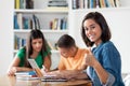 Successful spanish female student with group of learning students Royalty Free Stock Photo