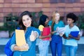 Successful spanish female student with group of students Royalty Free Stock Photo