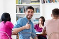 Successful spanish male student with group of students at library of university Royalty Free Stock Photo