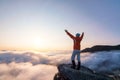 Successful sporty girl is standing at the edge of the precipice. Mountains landscape in the foggy morning. Sunrise. Autumn Royalty Free Stock Photo