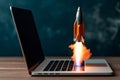 Successful Startup Concept Rocket Launching from Laptop Screen, Office Desk Background, Digital Business Growth Visual. Generative