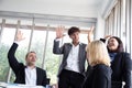 Successful startup entrepreneurs and business people team achieving goals celebrating giving high five in office. Royalty Free Stock Photo