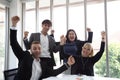 Successful startup entrepreneurs and business people team achieving goals celebrating giving high five in office. Royalty Free Stock Photo