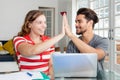 Successful student couple give high five