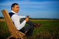 Successful Stylish Mid Adult Man Drinking Wine In Green Field.