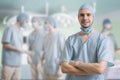 Successful surgeon is smiling. A lot of surgeons in background Royalty Free Stock Photo