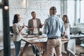 Successful team. Diverse group of young business people drinking Royalty Free Stock Photo