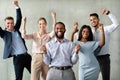 Successful Team. Group Of Multiracial Colleagues Celebrating Business Achievement With Raised Fists