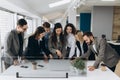 Successful team. Group of young business people working and communicating together in creative office Royalty Free Stock Photo