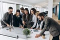 Successful team. Group of young business people working and communicating together in creative office Royalty Free Stock Photo