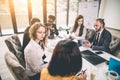 Successful team leader and business owner leading informal in-house business meeting. Businessman working on laptop in Royalty Free Stock Photo