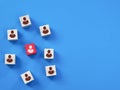 Wooden cube block with people icon standing out from the crowd. Royalty Free Stock Photo