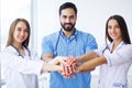 Successful team of medical doctors are looking at camera and smiling while standing in hospital Royalty Free Stock Photo