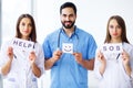 Successful team of medical doctors are looking at camera and smiling while standing in hospital Royalty Free Stock Photo