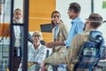 Successful team at work. Group of multi ethnic business people discussing something, communicating and smiling while Royalty Free Stock Photo