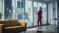 Successful Thoughtful Businesswoman Wearing Perfect Red Suit Standing in Office Looking out of Royalty Free Stock Photo