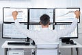 Successful Trader With Arms Raised Looking At Graphs On Screens Royalty Free Stock Photo