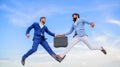 Successful transaction between businessmen.Easy deal business. Businessmen jump fly mid air while hold briefcase. Case