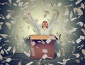 Successful woman coming out from a box under money rain Royalty Free Stock Photo