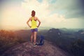 Woman hiker enjoy the view hiking on mountain peak