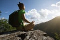 Woman hiker meditation on mountain top cliff edge Royalty Free Stock Photo