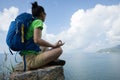 woman hiker meditation on mountain top cliff edge Royalty Free Stock Photo