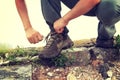 Woman hiker tying shoelace on the top of great wall