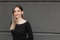 Successful woman portrait. Young businesswoman standing in front of a wall Royalty Free Stock Photo