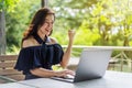 Successful woman using laptop with arms raised Royalty Free Stock Photo