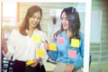 Successful women startuppers discussing plan together for work smiling and gesturing, happy women having friendly conversation