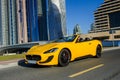 Successful yang businessman in yellow cabrio car.