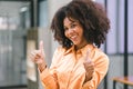 Successful young African American pretty woman, entrepreneur in casual wear, smiling, working on laptop in a modern Royalty Free Stock Photo