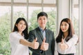 Successful young Asian business people showing thumb up Royalty Free Stock Photo