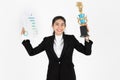 Successful young Asian business woman celebrating with trophy award over white isolated background. Success achievement in Royalty Free Stock Photo